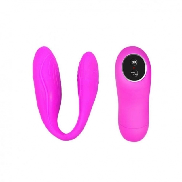 Vibrador para casal em formato de U e controle de vibração ao lado dele. Ambos na cor rosa